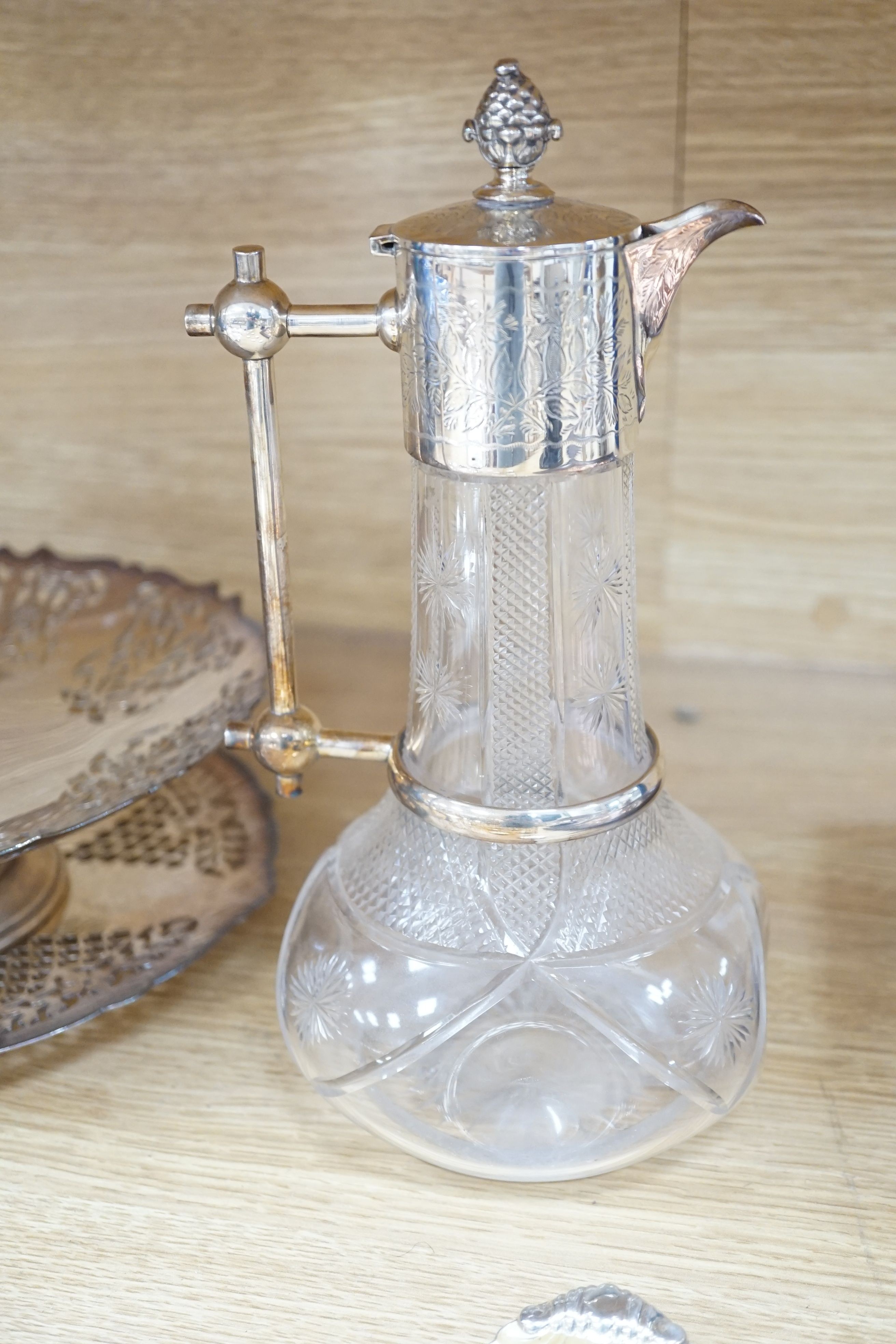 A late Victorian plate mounted cut glass claret jug of onion shape, height 25.6cm a graduated set of plated compotes, pierced circular dish tops, on pedestal stems, makers Mappin & Webb, largest diameter 24.5cm and six p